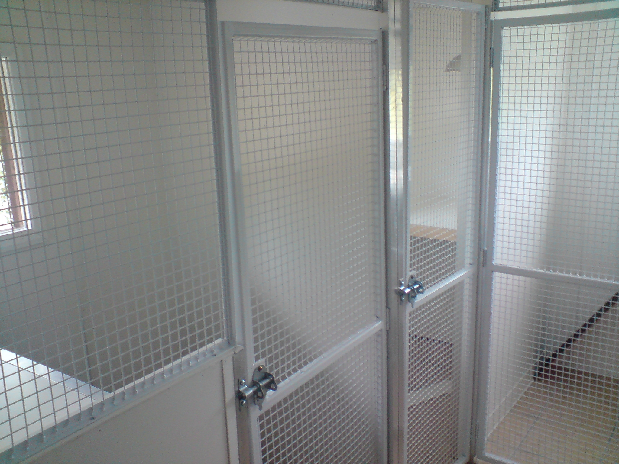 Multiple enclosures, with padlockable gates, all panels powder coated white