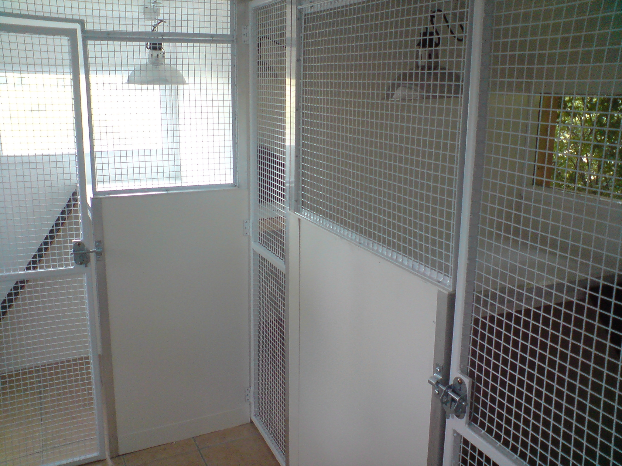Multiple enclosures, with padlockable gates, all panels powder coated white