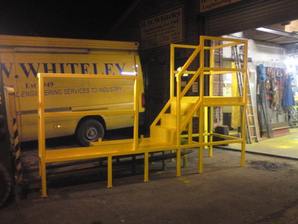 Work platform with safety barrier & kick plate to conform with safety regulations